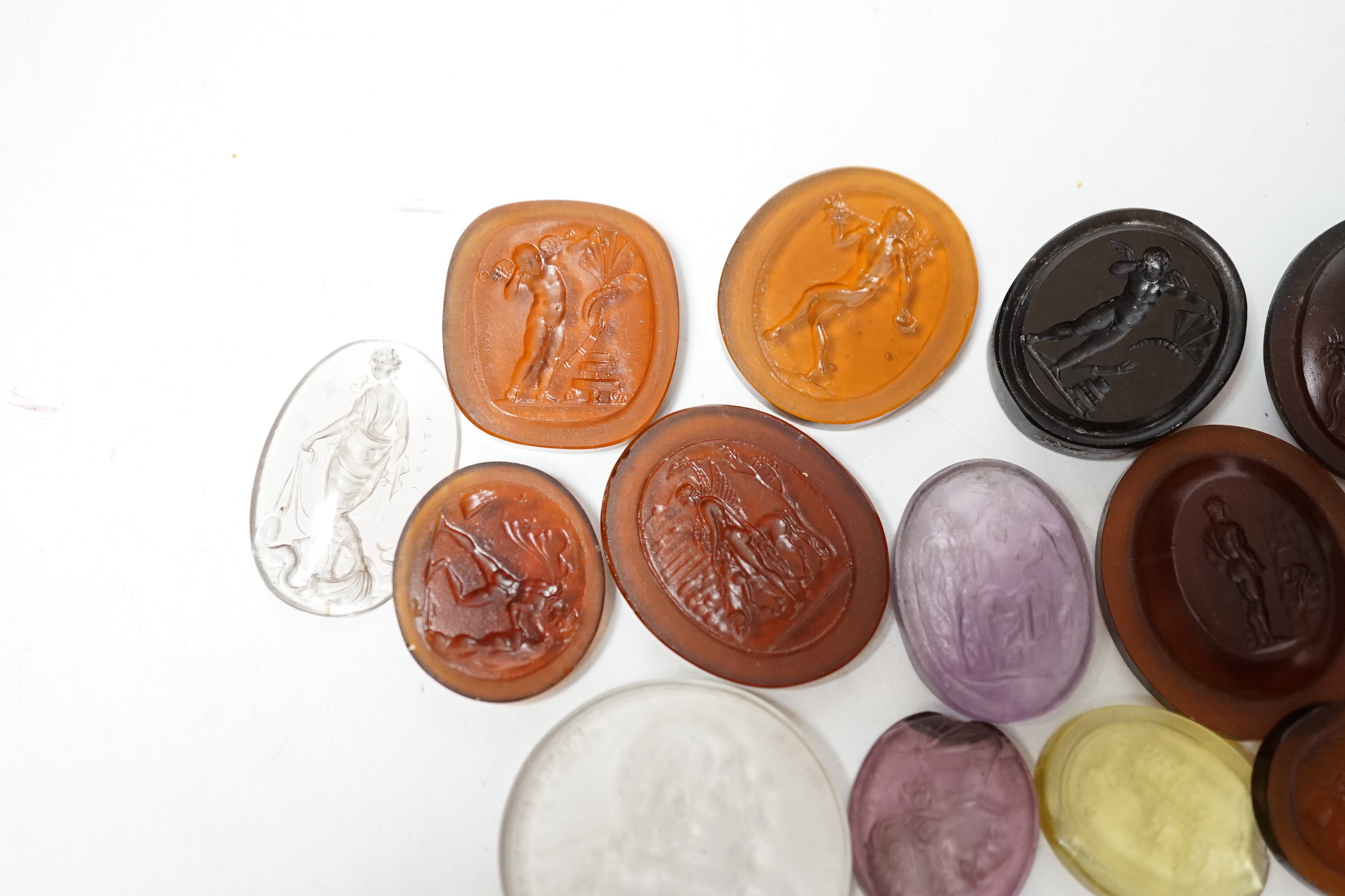 Fourteen 19th century intaglio glass matrices, largest approx. 3cm diameter